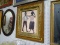 (WALL) FRAMED AFRICAN ARTWORK; DEPICTS A MAN AND A WOMAN DANCING WITH A PINK BACKGROUND. IS IN A