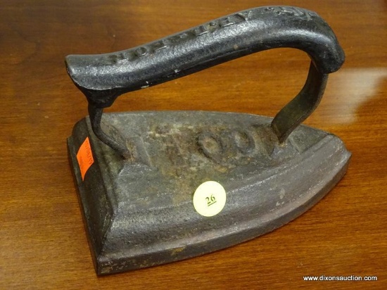 (R1) CAST IRON IRON; HAS LETTERS ENGRAVED ON THE HANDLE. MEASURES 6.5 IN LONG.