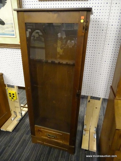 (R1) GUN CABINET; WOODEN 6 SLOT GUN CABINET WITH A GLASS FRONT DOOR THAT HAS A BASS PULL HANDLE AT