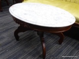 (R3) COFFEE TABLE; WHITE MARBLE TOP, OVAL, WOODEN COFFEE TABLE WITH 4 SPIDER LEGS. MEASURES 33.5 IN