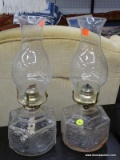 (R4) PAIR OF OIL LAMPS; 2 CLEAR GLASS OIL LAMPS WITH CHIMNEYS. BOTH ARE MADE BY PARMS LAMP CO.