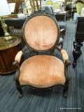 (R4) VICTORIAN ARMCHAIR; HAS PINK UPHOLSTERED BACK AND ARMS WITH ROSE CARVING ALONG THE TOP. IS IN
