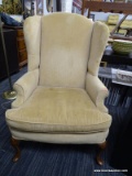 (R4) WING CHAIR; 1 OF A PAIR OF YELLOW UPHOLSTERED WING BACK CHAIRS WITH SHELL CARVED KNEES AND