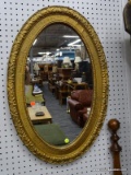(BACK WALL) OVAL FRAMED MIRROR; GOLD GILT FRAMED OVAL MIRROR IN VERY GOOD CONDITION. MEASURES 19 IN