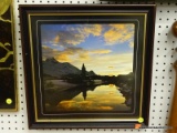 (BACK WALL) SUNSET PRINT; DEPICTS A MOUNTAINOUS VILLAGE SUNSET NEAR THE WATER. IS IN A BLACK FRAME