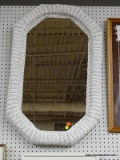 (BACK WALL) OCTAGONAL MIRROR; WHITE WICKER FRAMED MIRROR IN EXCELLENT CONDITION. MEASURES 19 IN X 38