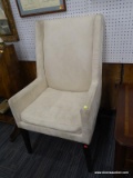 (WALL) WING BACK ARM CHAIR; CREAM UPHOLSTERED ARM CHAIR WITH A WING BACK AND BLACK TAPERED BLOCK