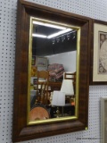 (WALL) WALL HANGING MIRROR; MIRROR SITS IN A BRASS TONED FRAME AND WOODEN FRAME. MEASURES 25.25 IN X
