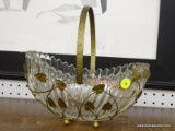 (R1) GLASS BASKET; BASKET ITS IN A METAL CASE WITH LEAF DETAILING. MEASURES 10 IN WIDE 9 IN TALL.
