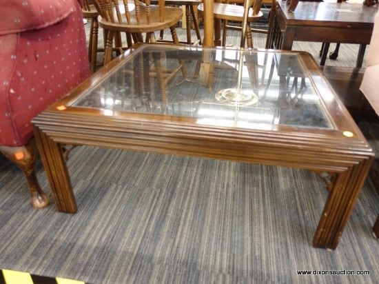 (R1) GLASS TOP COFFEE TABLE; WOODEN COFFEE TABLE WITH A GLASS TOP AND TERRACED EDGES. HAS REEDED