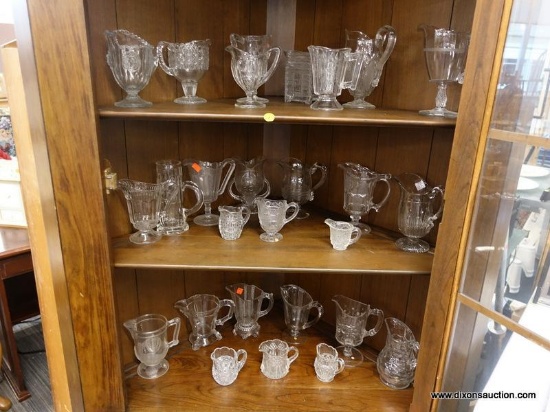 (R1) LOT OF ASSORTED GLASS PITCHERS; 27 PIECE LOT OF ASSORTED GLASS PITCHERS OF DIFFERENT SHAPES AND