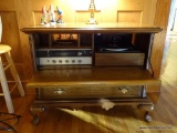 (FRM) STEREO; PECAN FINISHED QUEEN ANNE STEREO CABINET WITH DROP FRONT- CONTAINS A MAGNAVOX AM/FM