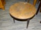 (R2) WALNUT CHILDS TABLE; ROUND TABLE WITH 3 TAPERED LEGS. MEASURES 20 IN TALL WITH A 20 IN