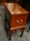 (R2) TRUNK ON LEGS; SMALL, WOODEN TRUNK SITTING ON A BASE WITH BLOCK LEGS AND FLORAL BRACKET