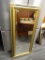 (BACKWALL) FRAMED MIRROR; BEVELED GLASS MIRROR WITH A GOLD TONE AND CRACKED GREEN FRAME. HAS LEAF