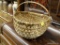 (BAY 6) ROCKING BASKET; WICKER ROCKING BASKET WITH AN ARCHING HANDLE. HAS MINOR DAMAGE TO THE WOOD.