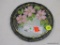 (BAY 6) PORCELAIN TEA TILE; HAND PAINTED WITH PINK FLOWERS AND GOLD TONE DETAILING. MEASURES 6.25 IN