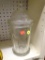 (BAY 6) VINTAGE PHARMACY LIDDED GLASS CONTAINER; HAS THICK GLASS. MEASURES 12 IN TALL WITH A 5.25 IN