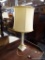 (R2) TABLE LAMP; CREAM MARBLE REEDED COLUMN TABLE LAMP. COMES WITH A DRUM SHAPED LIGHT BROWN COOLIE.