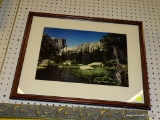 (WALL) FRAMED LANDSCAPE PRINT; SHOWS A PHOTO OF A VIEW FROM THE BOTTOM OF A MOUNTAIN VALLEY WITH