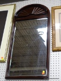 (WALL) FRAMED MIRROR; BEVELED GLASS MIRROR IN A GLOSS FINISHED WOODEN FRAME WITH A FAN CARVING AT