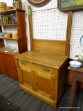 (R1) OAK WASHSTAND; EASTLAKE OAK WASHSTAND WITH TOP TOWEL BAR, 1 DRAWER, AND 2 LOWER DOORS. HAS