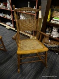(R1) HEYWOOD WAKEFIELD ARMCHAIR SEWING ROCKER; HAS A CANE SEAT WITH A WICKER BACK. ALSO HAS ORIGINAL