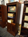 (R1) LIBRARY WITH DOORS; HAS 2 ADJUSTABLE SHELVES ON THE UPPER PART OF THE BOOKCASE, AND HAS 2 LOWER