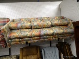 (WALL) 3-CUSHION SOFA; HAS A PASTEL, LEAF DETAILED, UPHOLSTERED FABRIC. IN GOOD CONDITION. PERFECT