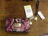 (R2) BIG BUDDHA WALLET; FUCHSIA FAUX CROCODILE SKIN LOOKING WALLET WITH A STRAP HANDLE AND A ZIPPER.