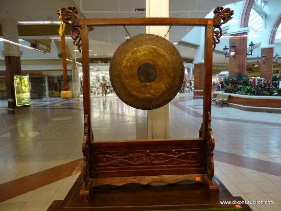 (WINDOW) GONG; ORIENTAL GONG AND MALLET SITTING IN A WOODEN, HAND CARVED FRAME WITH DRAGONS CARVED