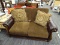 (R4) DURABLEND BLENDED LEATHER LOVESEAT; BROWN LOVESEAT WITH SCROLL DETAILED ROLLING LEATHER ARMS.