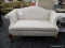 (R4) CLAYTON MARCUS LOVESEAT; ROLL ARM, CAMEL BACK LOVESEAT WITH A CREAM FLORAL UPHOLSTERY. SITS ON