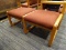 (R4.5) LOBBY/WAITING ROOM OTTOMAN; HAS 2 SEPARATE LEG RESTS WITH BURGUNDY UPHOLSTERING AND A SOLID