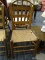 (R4.5) LADDER BACK SIDE CHAIR; SLAT BACK, MULE EAR SIDE CHAIR WITH A WOVEN, STAINED RATAN SEAT.