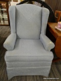 (R2) CRAFTMASTER WINGBACK ARM CHAIR; HAS ROLLING ARMS AND A LIGHT BLUE UPHOLSTERY WITH WHITE ACCENTS