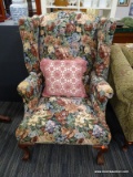(R3) WINGBACK ARMCHAIR; FLORAL UPHOLSTERED WINGBACK ARMCHAIR WITH ROLLING ARMS AND CLAW AND BALL