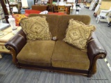 (R4) DURABLEND BLENDED LEATHER LOVESEAT; BROWN LOVESEAT WITH SCROLL DETAILED ROLLING LEATHER ARMS.
