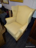 (R5) WINGBACK ARMCHAIR; LIGHT ORANGE/PEACH WINGBACK ARM CHAIR WITH AN H STRETCHER AND REEDED LEGS.