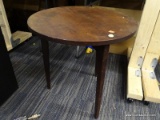 (R5) WALNUT CHILDS TABLE; ROUND TABLE WITH 3 TAPERED LEGS. MEASURES 20 IN TALL WITH A 20 IN