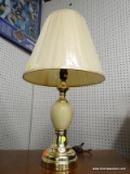 (R1) TABLE LAMP; URN SHAPED CREAM COLORED TABLE LAMP WITH GOLD BASE AND TOP. COMES WITH CREAM COOLIE