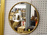 (LWALL) ROUND HANGING MIRROR; MIRROR SITS IN A GOLD TONED FRAME. HAS A 16 IN DIAMETER.