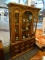 (WINDOW) CHINA CABINET; 2 PC. CHINA CABINET WITH METAL TASSEL PULLS. TOP PIECE HAS A BLOWN GLASS