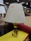 (R2) BRASS TABLE LAMP; URN SHAPED TABLE LAMP WITH DENTAL DETAILING AND A TURNED BASE. COMES WITH A