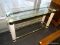 (WINDOW) GLASS TOP SOFA TABLE; HAS A RECTANGULAR GLASS TABLE TOP WITH A 4 REEDED COLUMN POST AND 2