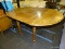 (R1) DROP LEAF TABLE; WOODEN TABLE WITH 15.5 IN LEAVES AND TURNED POLE LEGS SITTING ON WOODEN