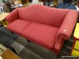 (R2) CAMELBACK SOFA; HAS ROLLING ARMS AND A REDDISH PINK UPHOLSTERY WITH A DIAMOND SHAPED PATTERN.