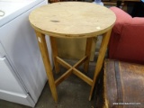 (R2) ROUND SIDE TABLE; WOODEN, ROUND END TABLE WITH AN X STRETCHER. NEEDS TLC AS ITS AN UNFINISHED