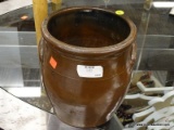 (R3) CROCK; BROWN GLAZED CROCK WITH 2 HANDLES. ONE OF THE HANDLES HAS A CHIP ON THE EDGE. MEASURES 9