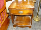 (R4) NIGHT STAND; WOODEN, BOWED FRONT, SINGLE DRAWER NIGHT STAND WITH A LOWER SHELF AND A SCALLOPED